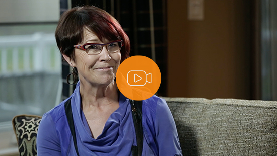 An Economical customer holds a picture of her damaged car in front of the fixed car