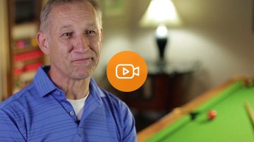 An Economical customer standing in front of his pool table