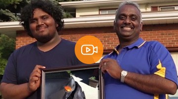 Economical customers, Father & son holding a picture of their damaged car