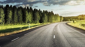 A country road with sunlight at the end