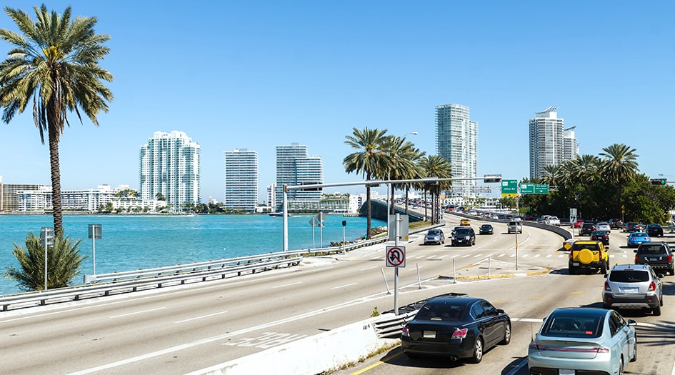 Here's what you need to know about your Canadian car insurance while in the US, as shown by a US highway by the ocean 