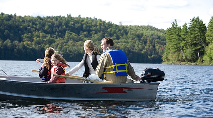 Before you hit the lake this summer, like this family of four in a motorboat, always follow these 5 safe boating tips