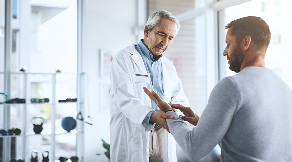 Here is what accident benefits coverage covers under car insurance, as shown by a man getting his hand checked by a doctor