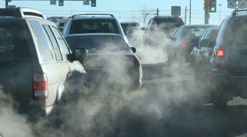 Cars wait at a traffic light with clouds of exhaust, showing how exhaust smoke colour can indicate your car’s health