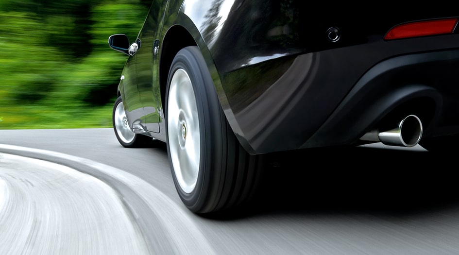 A close up of a car's tires while it drives shows how self-driving vehicles will affect car insurance in Canada