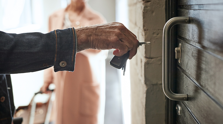 Here's the best kind of lock for your door, as shown by a close up of a hand putting a key in the door