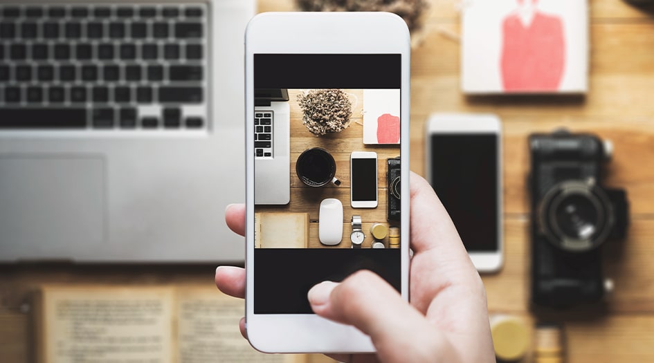 An overview of someone taking a photo of household items shows what prood of ownership is when meaking an insurance claim