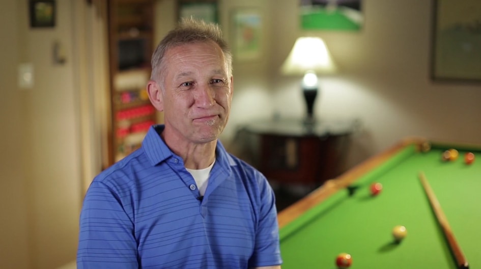 An Economical customer standing in front of his pool table