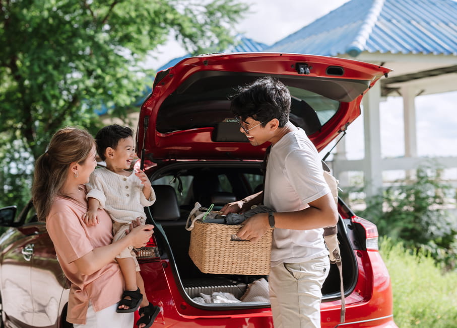 A family loading up their car with gear