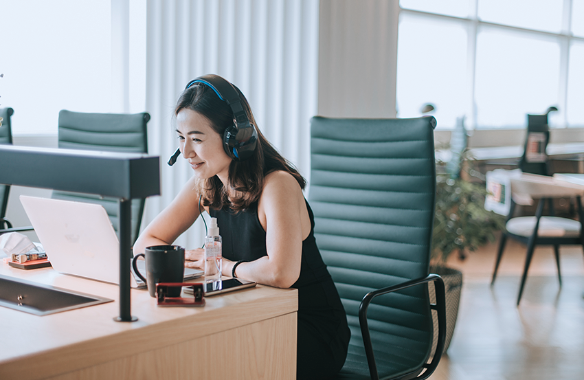 Une personne travaillant sur son ordinateur portable et parlant au téléphone