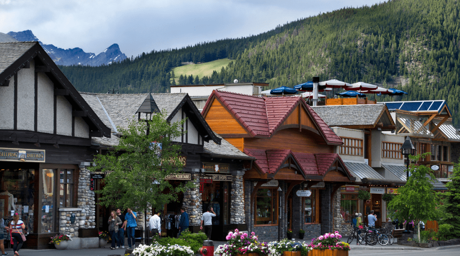 A row of small businesses by a forested hill show a region that should prepare for potential wildfire damage.